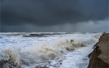 Dune erosion during storm surges: A review of the observations, physics and modelling of the collisio